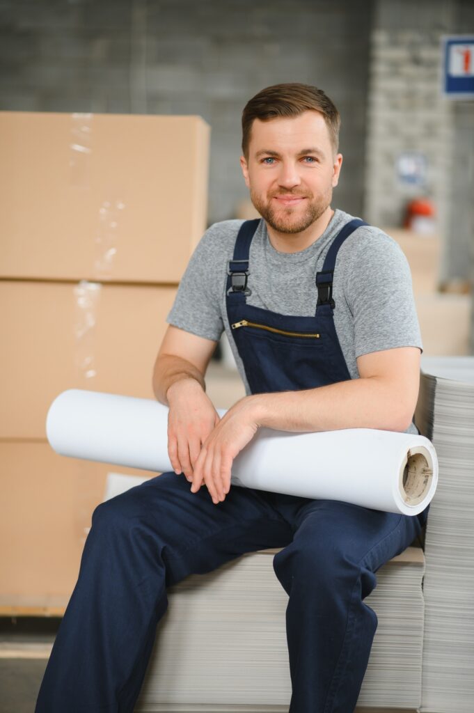 Male warehouse worker portrait in warehouse storage.